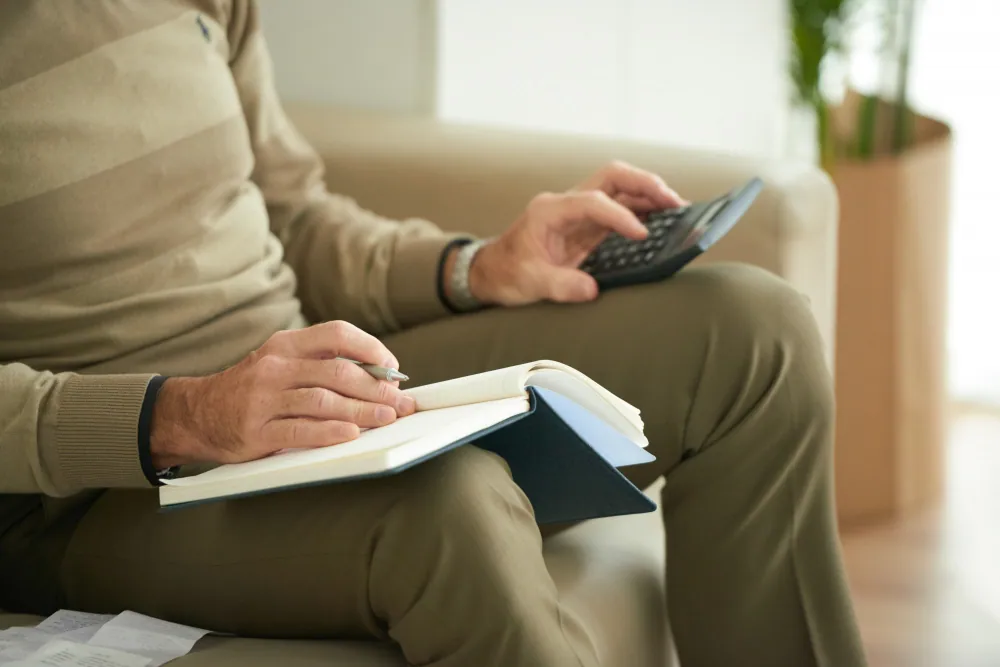 a mesothelioma patient writing down medical expenses for mesothelioma treatment. 