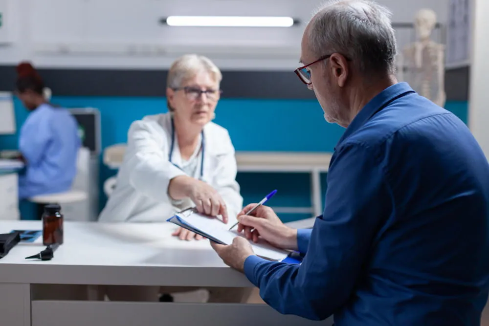 a mesothelioma patient seeking treatment, signing documents for billing