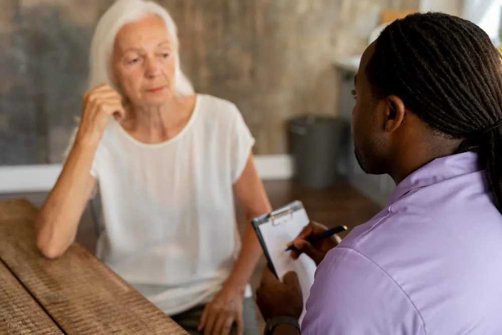 a patient advocate discussing caregiver support with a mesothelioma patient's caregiver