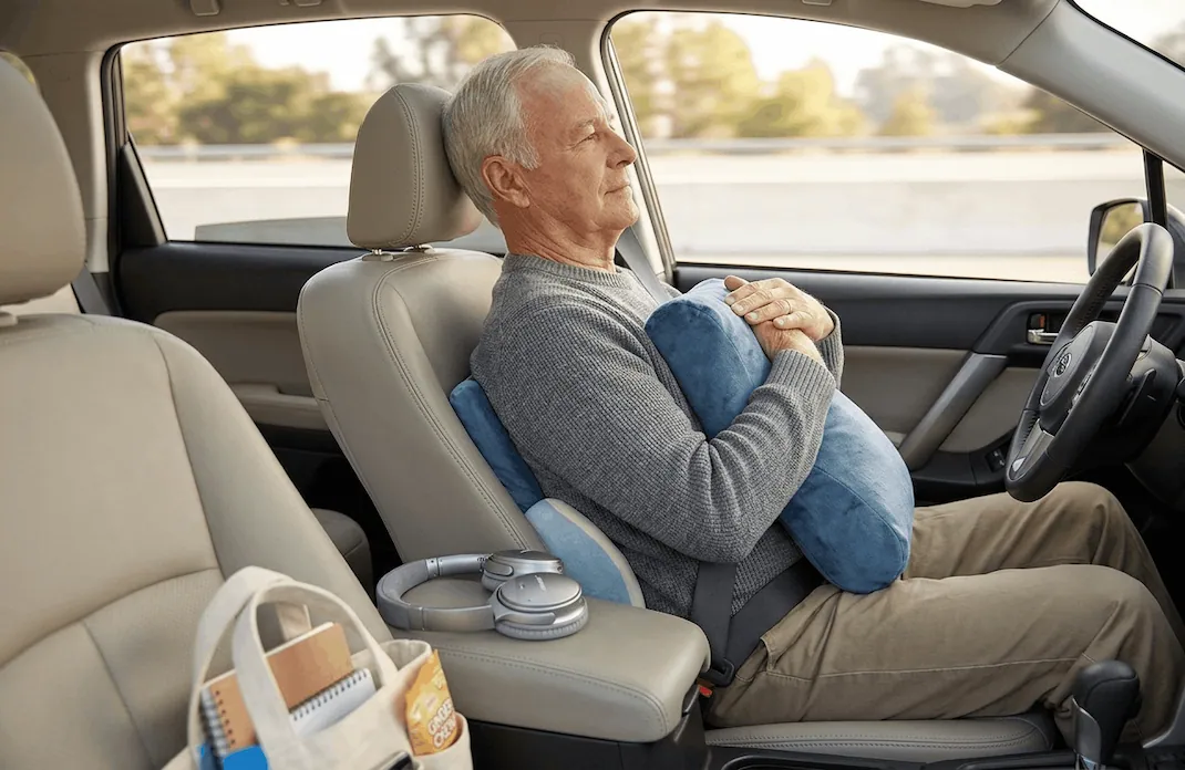 Ergonomic pillows positioned for rib and back support on a car seat for a mesothelioma patient.