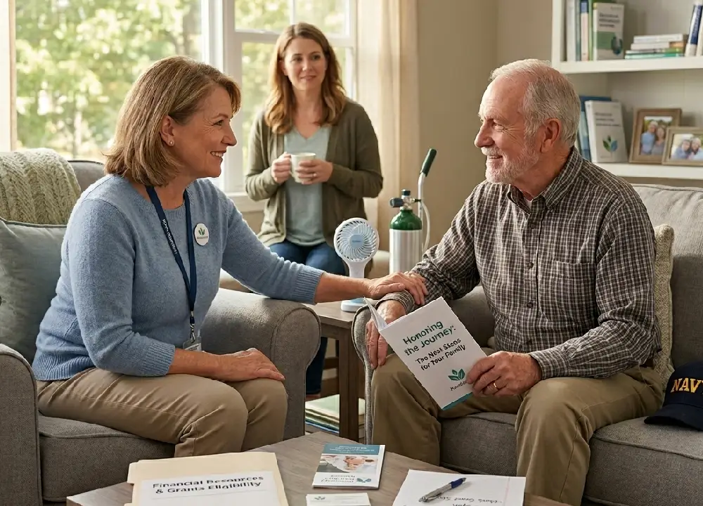 A MesoCare patient advocate sitting with a Navy veteran and his daughter in a comfortable living room, discussing medical resources and a financial grants eligibility folder.