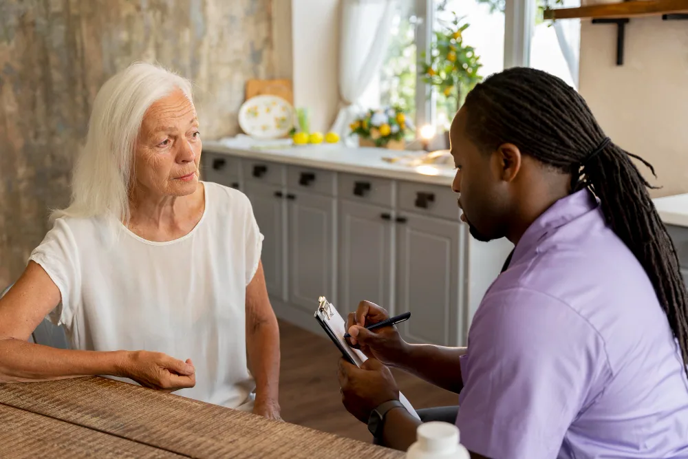 patient advocate helping a patient with paperworks related to accessing financial aid